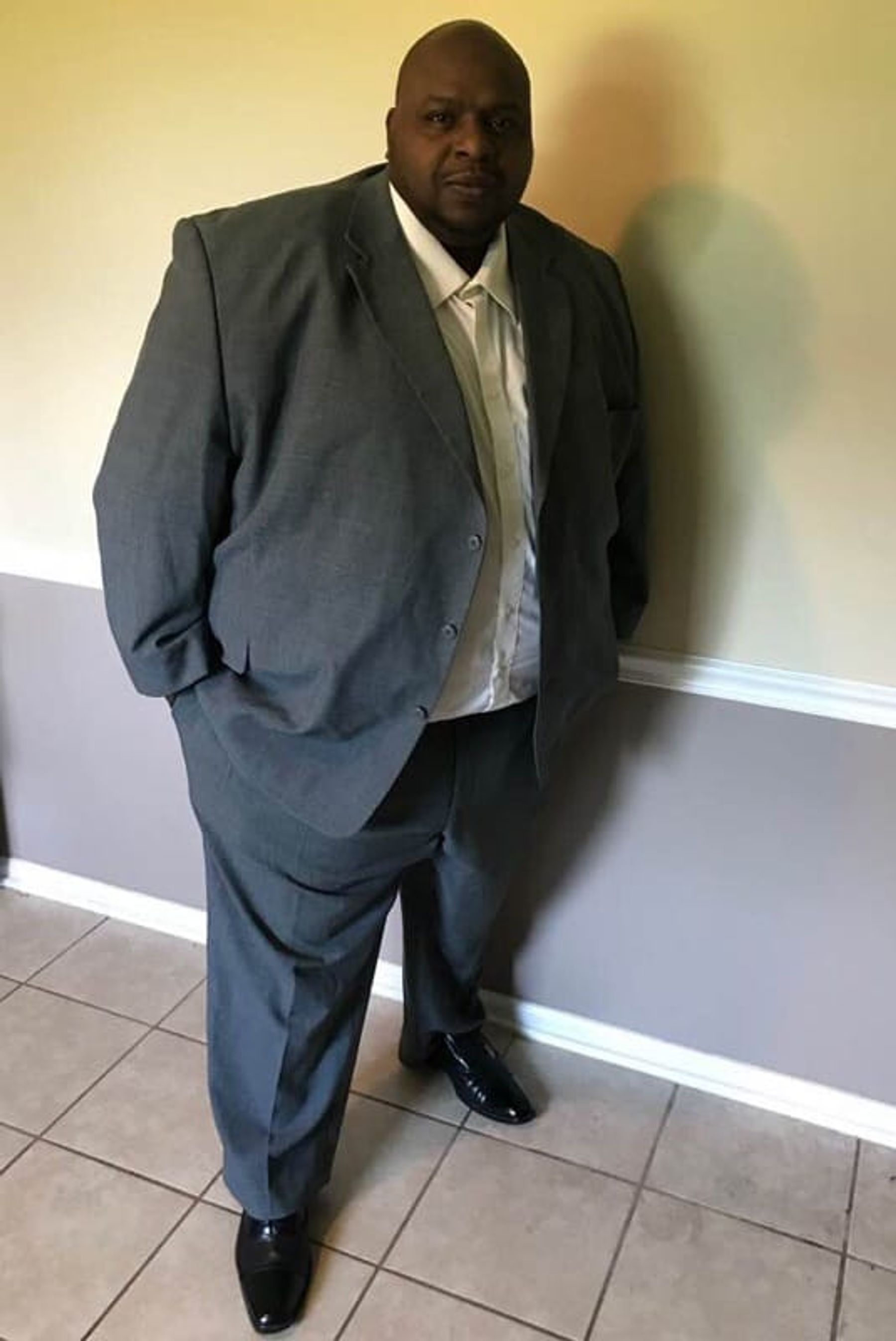 Dawan Hopson, founder of Kentucky Boy Entertainment LLC, standing in a gray suit.